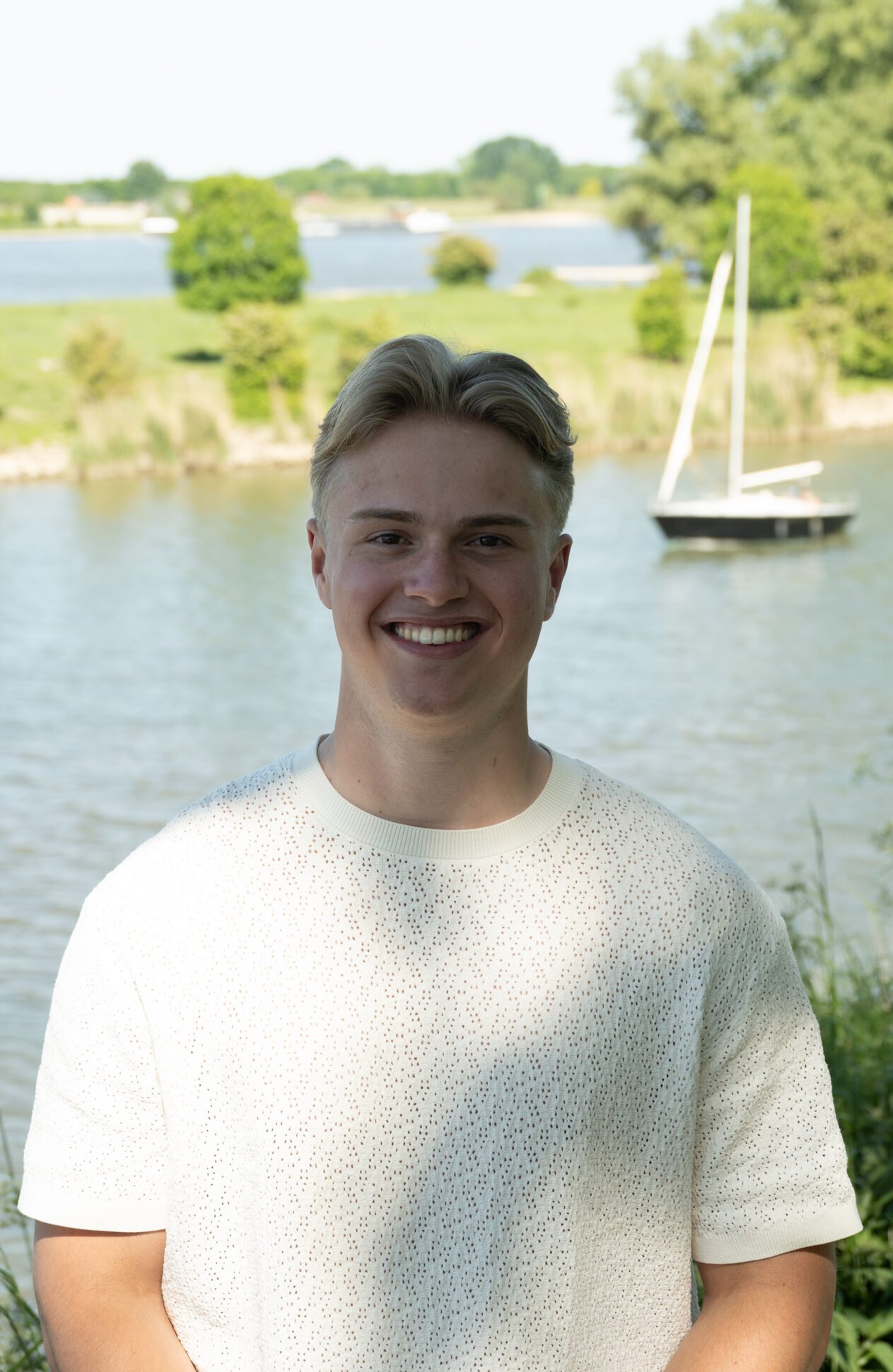 Lucan den Dekker smiling outdoors by the water